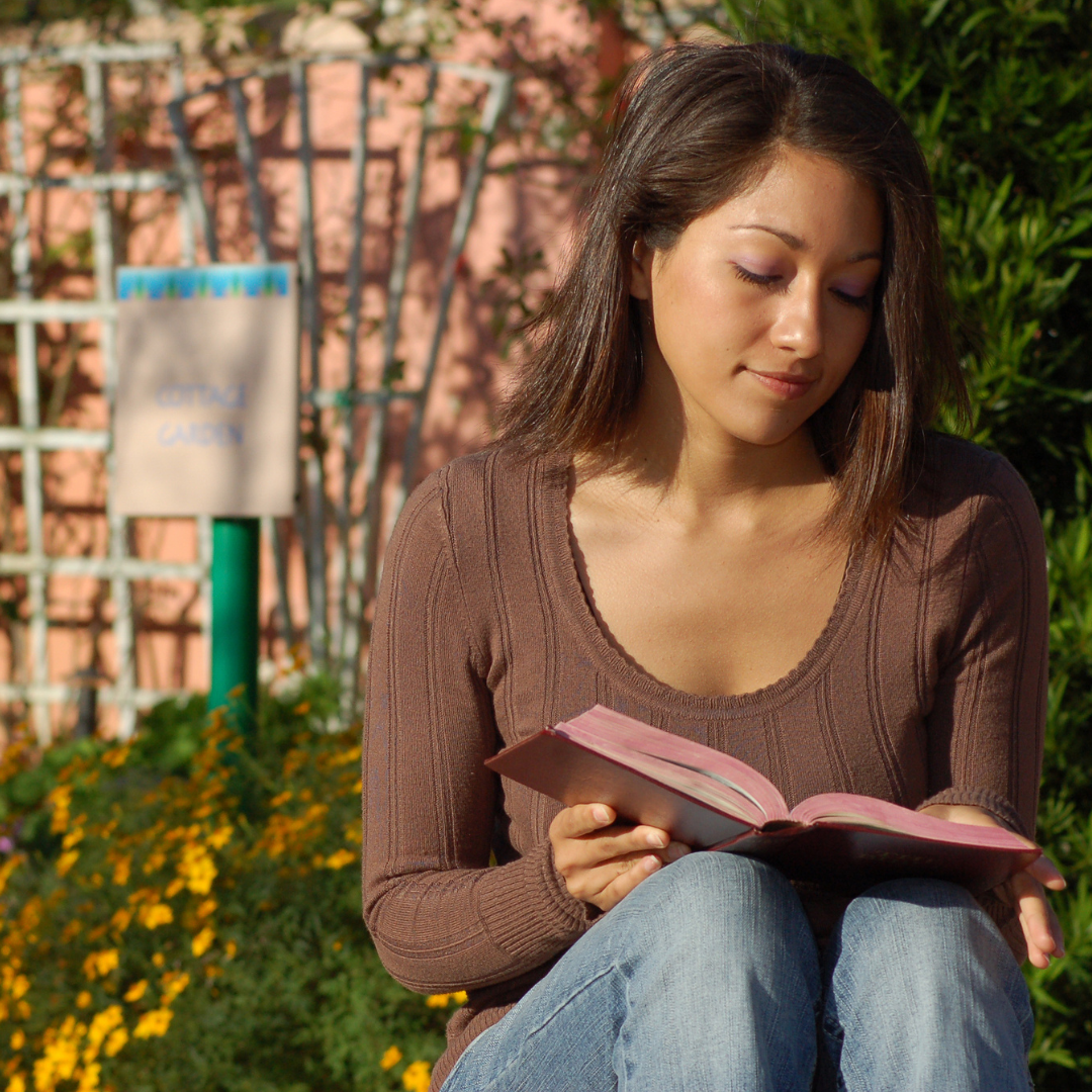 woman reading Bible in a garden