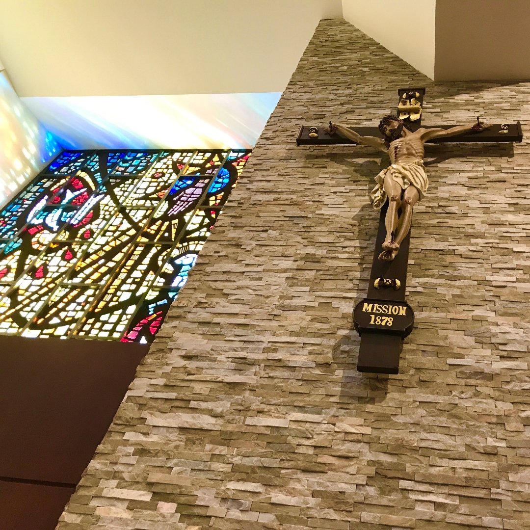 crucifix next to stained glass window
