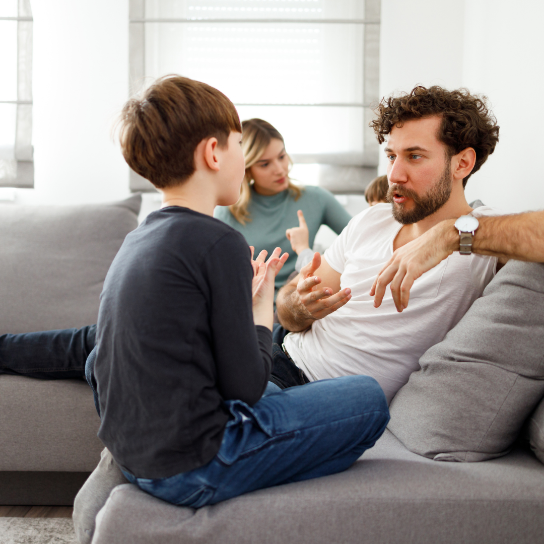 family sitting on couch talking