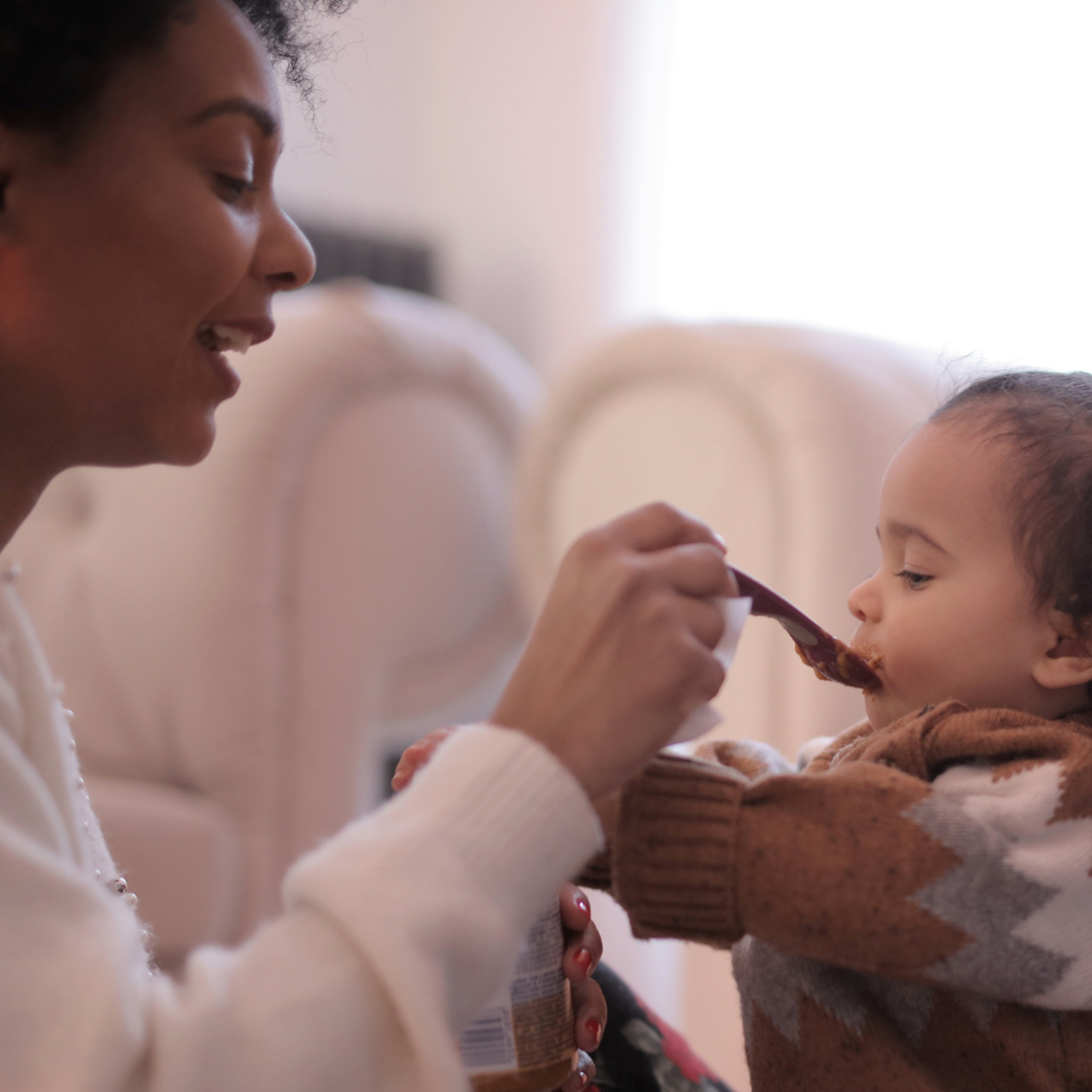 Mom feeding baby with a spoon