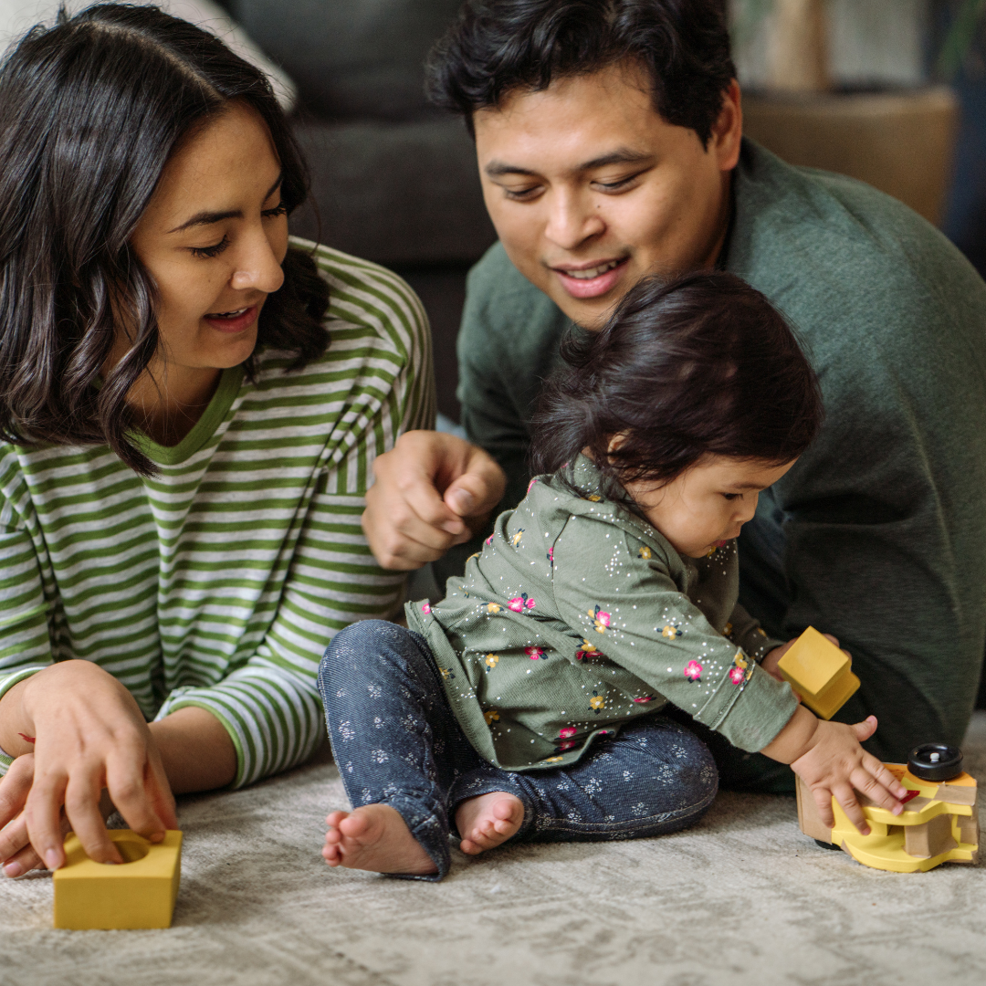 parents playing with small child