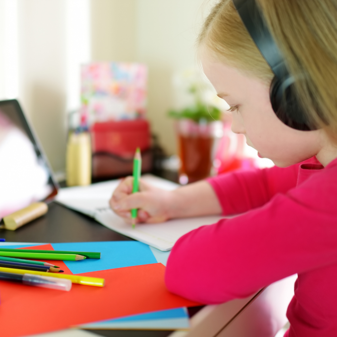girl with colored pencils, headphones, and tablet