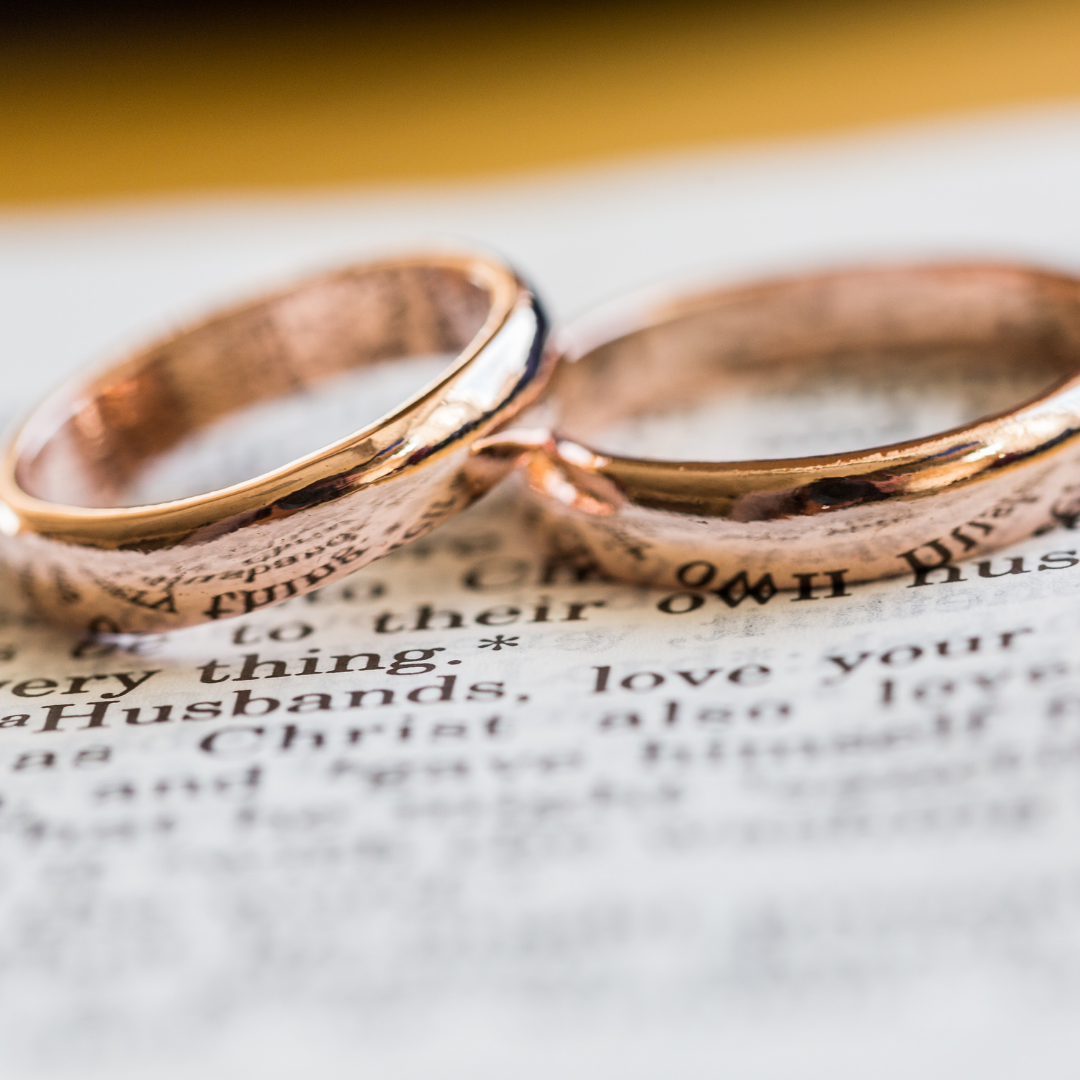wedding rings on top of a Bible