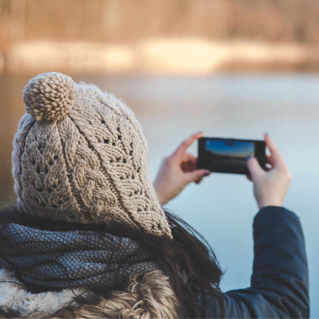 woman taking a photo with cell phone