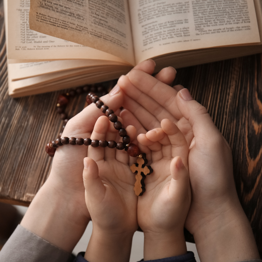 mother and child holding a Rosary and Bible