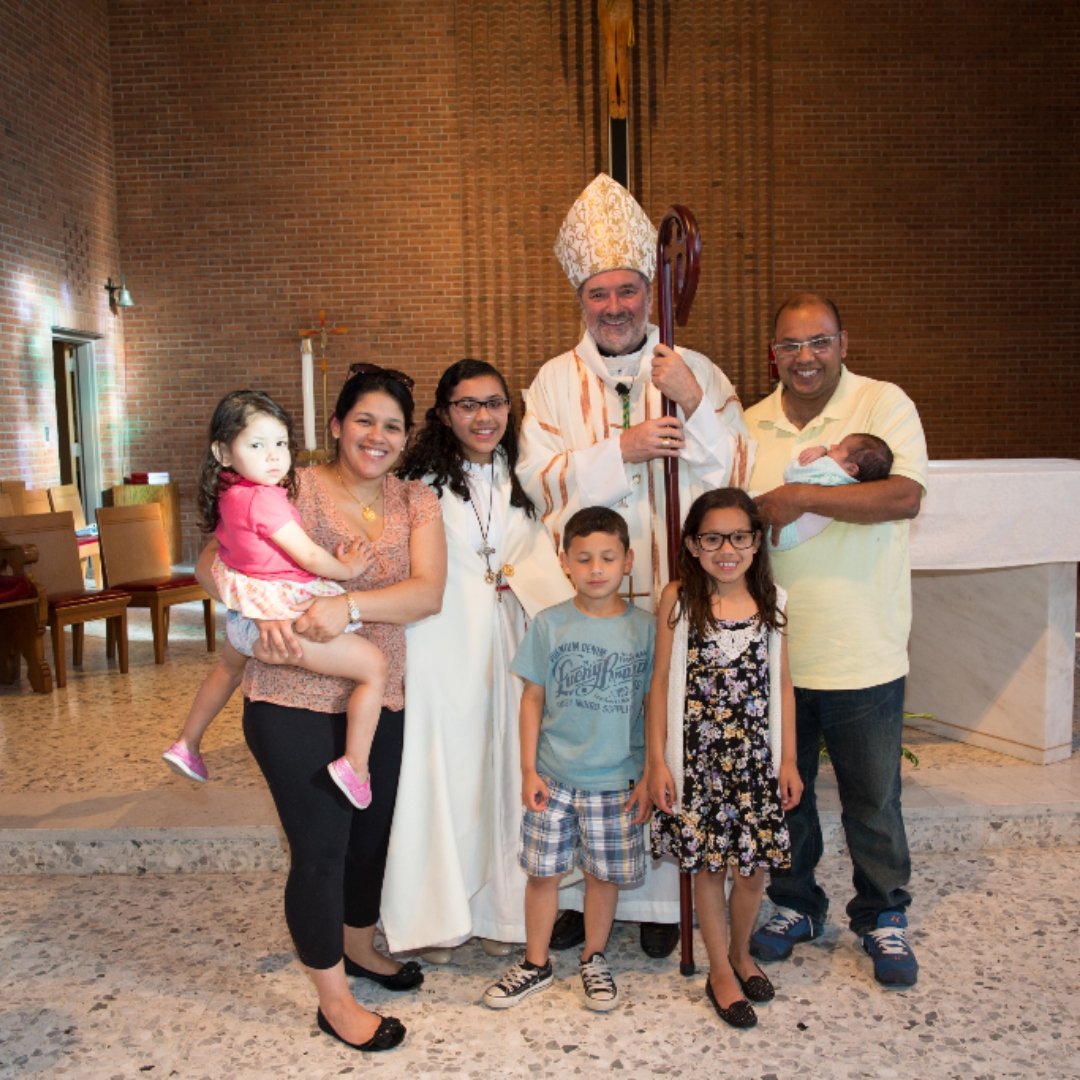family in church with bishop