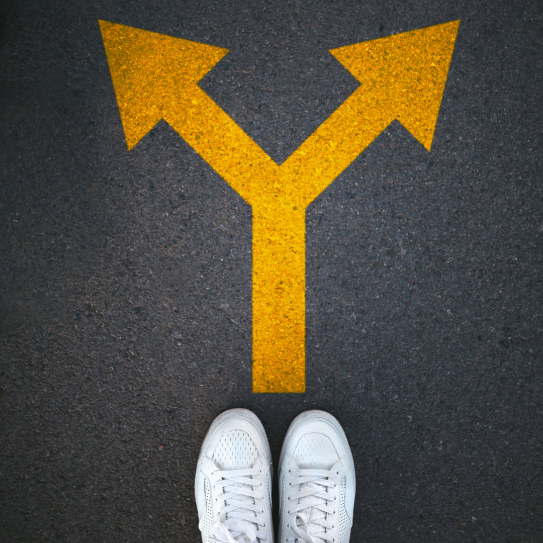 standing at an arrow pointing in 2 directions
