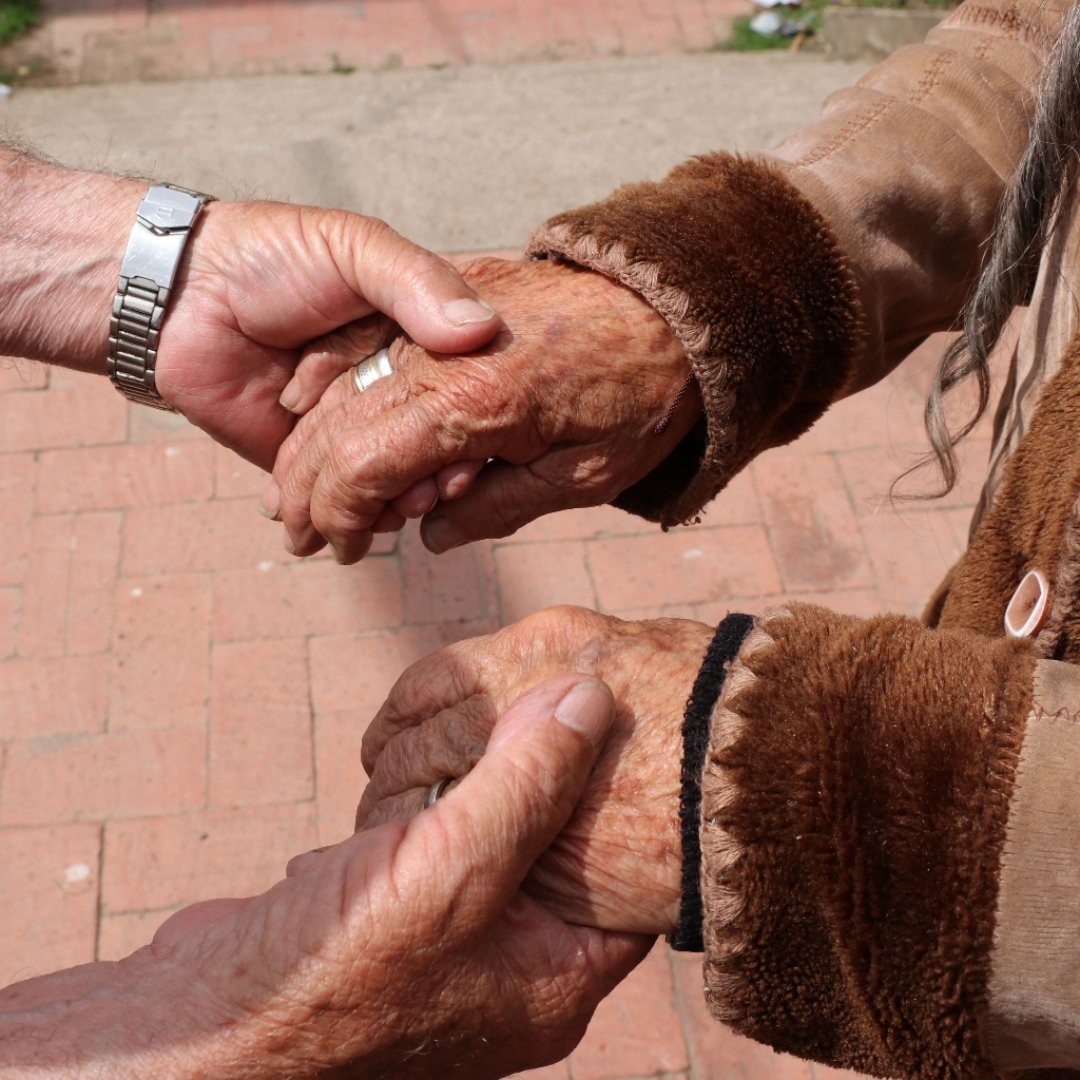sponsored elders from Unbound Jesus and Libia holding hands