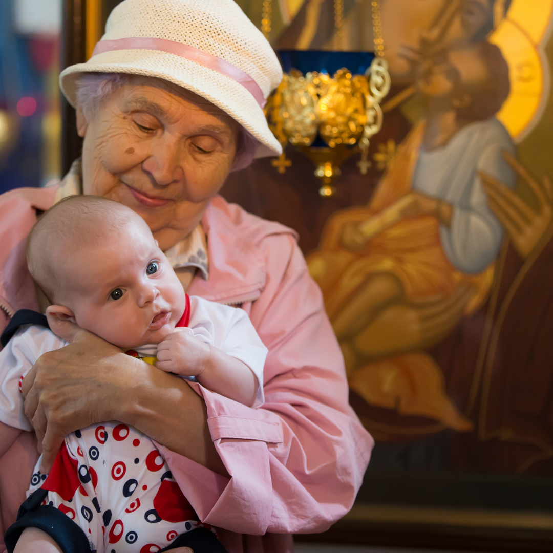 grandmother holding baby in church