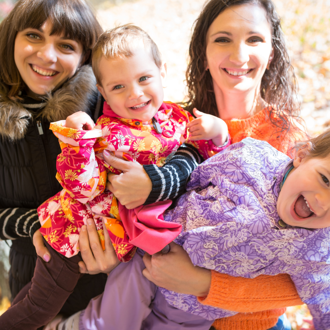 moms holding young children