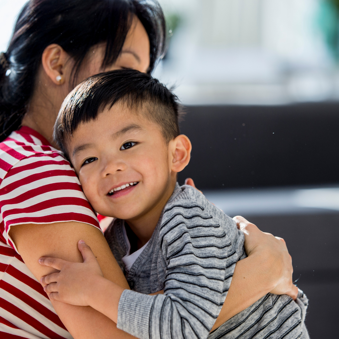mom hugging little boy