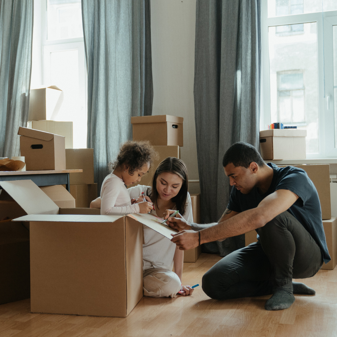 family packing moving boxes