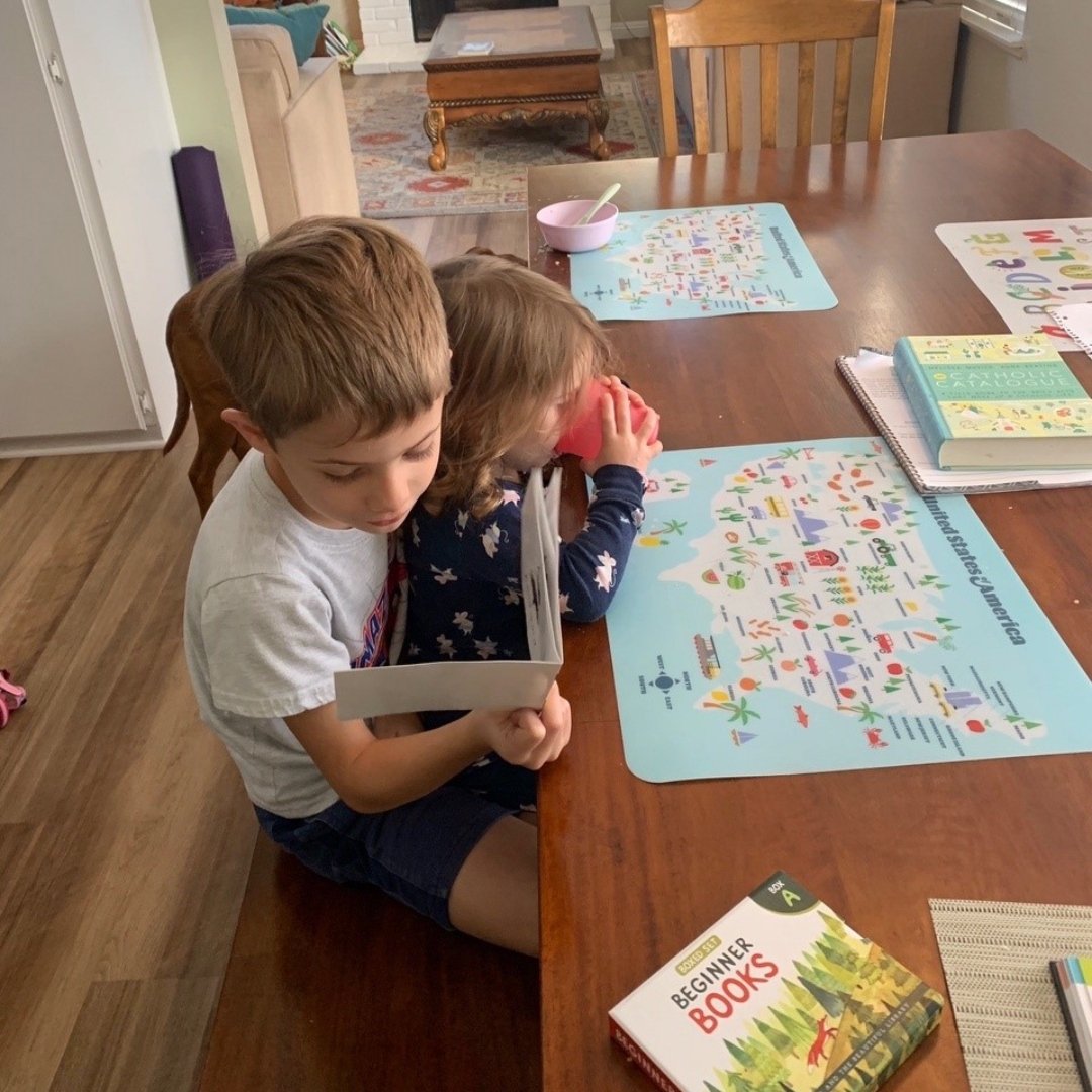 older child reading to younger one
