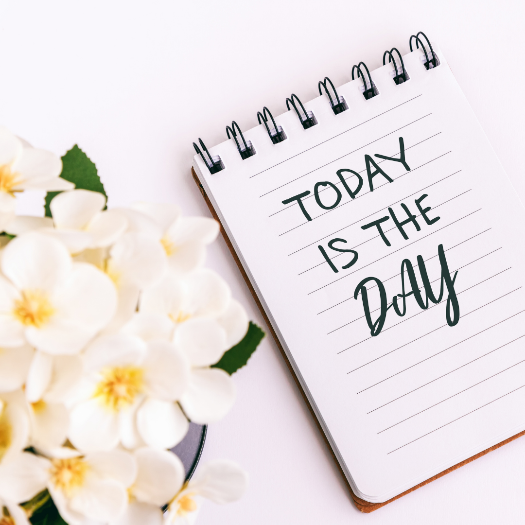 notepad with "today is the day" written on it