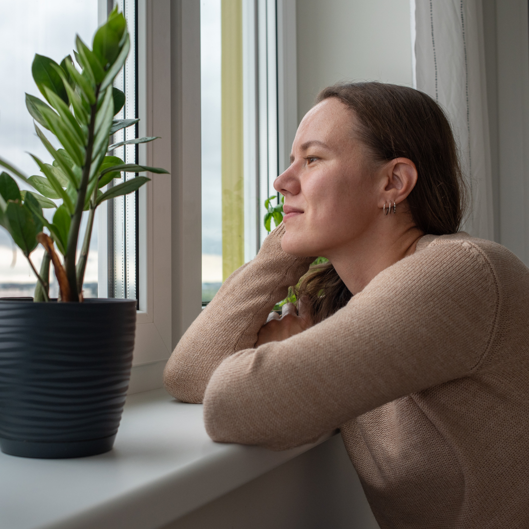 woman looking out the window