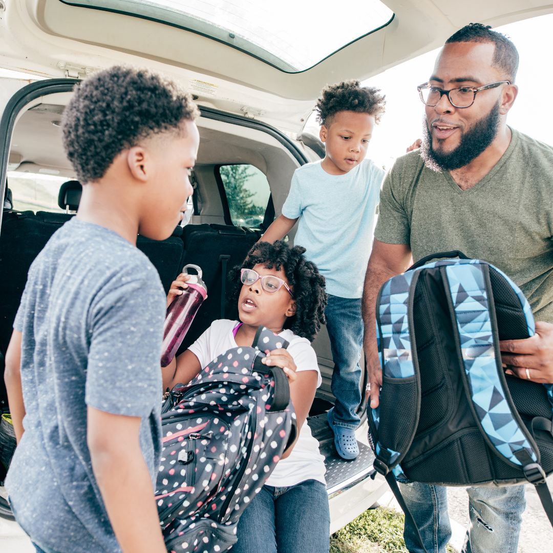 kids piling out of van and grabbing backpacks