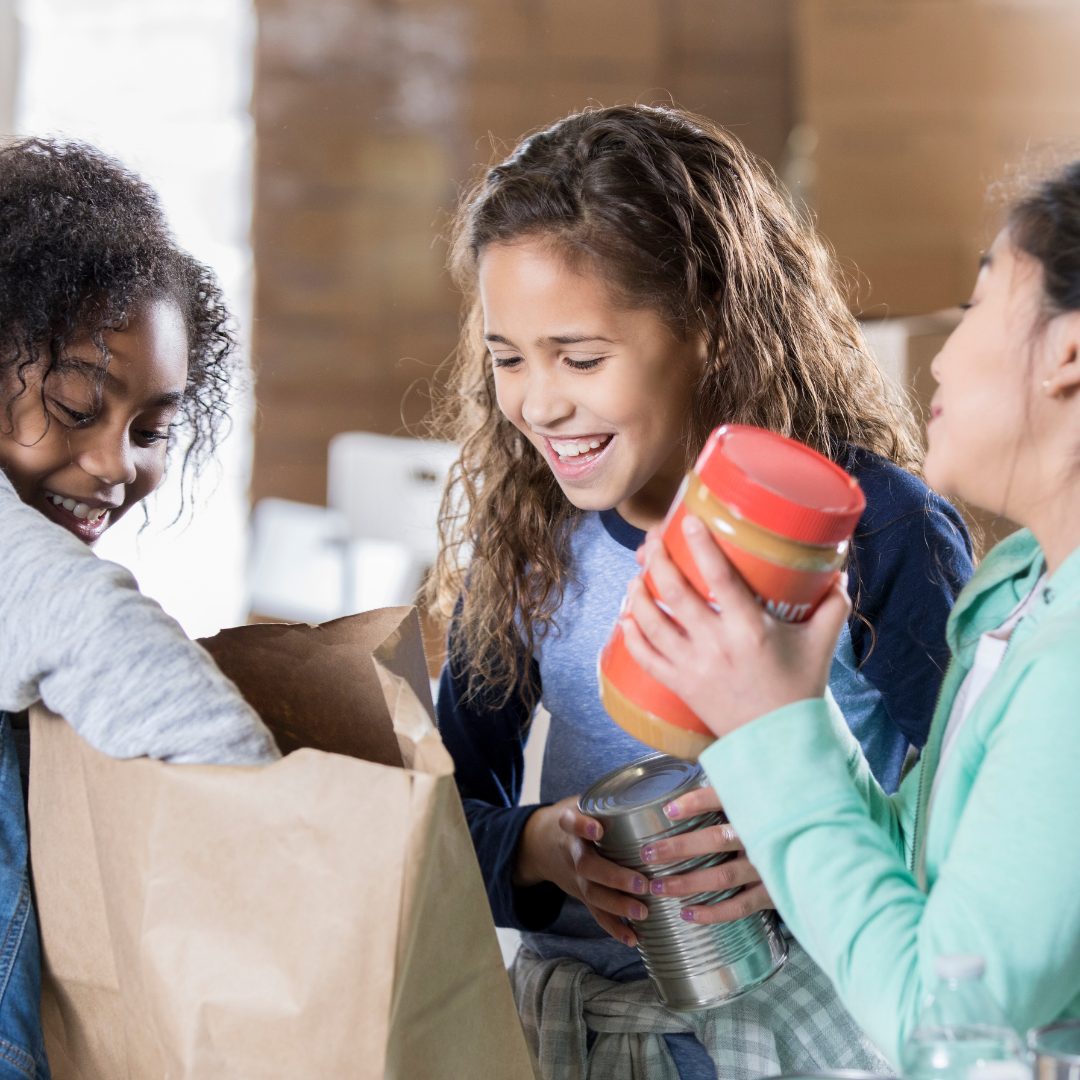 young girls packing bag at food pantry