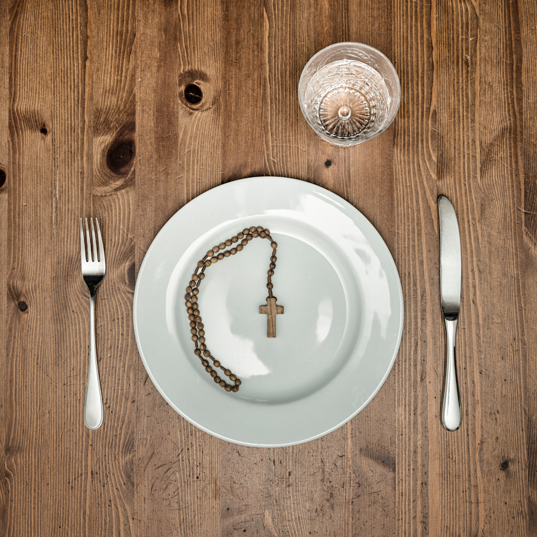 water glass and empty plate with Rosary