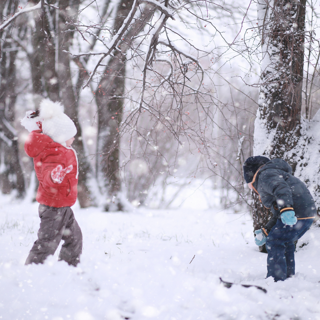 little kids throwing snowballs