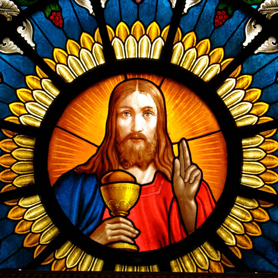 stained glass window of Jesus with Eucharist