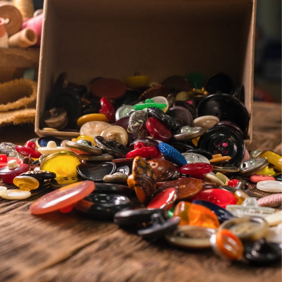 box of buttons spilling out onto the floor