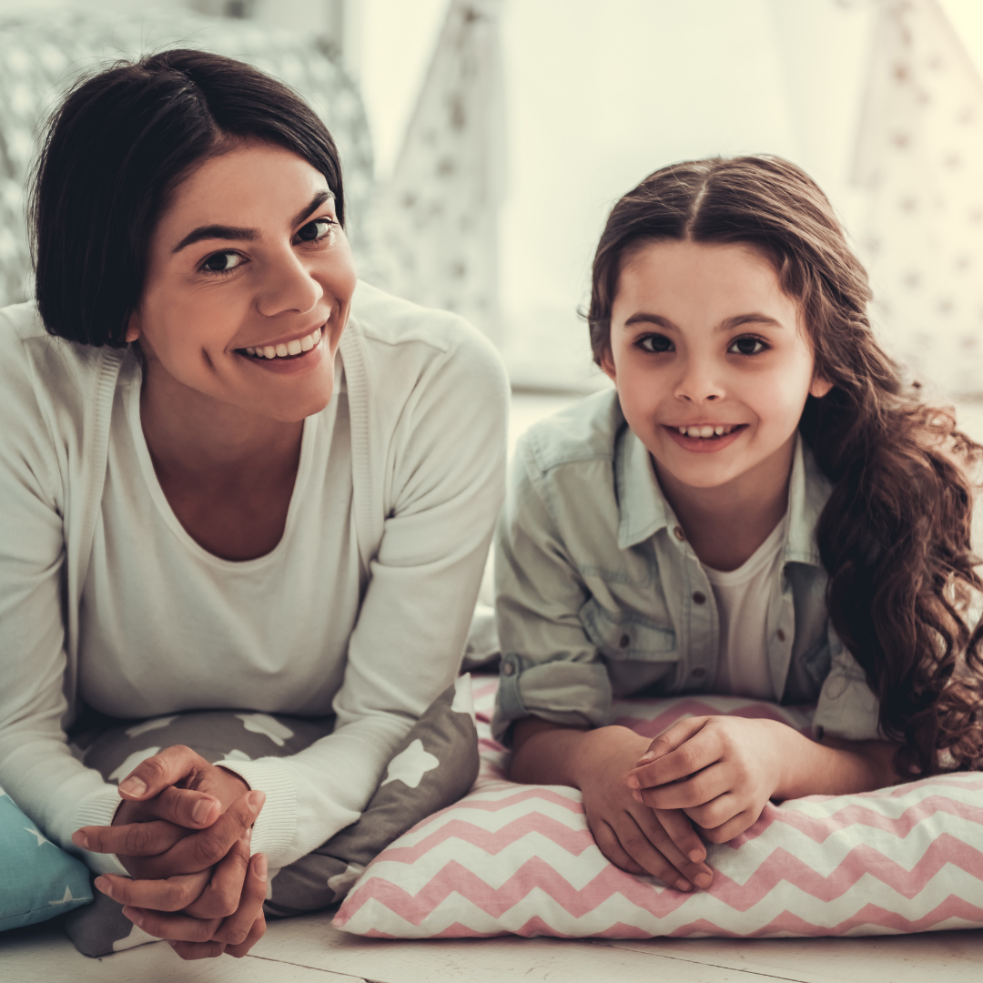 mother and tween daughter smiling