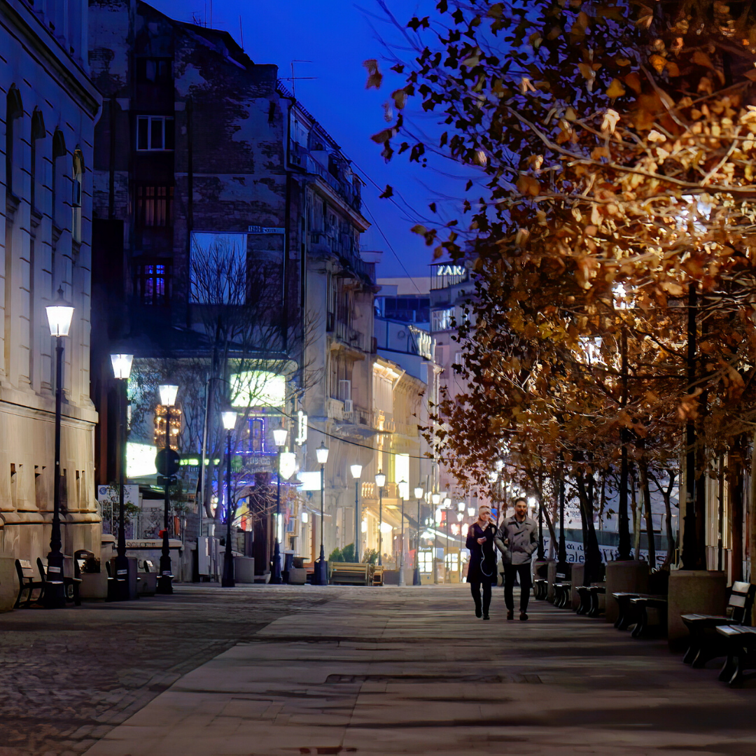 couple walking in a city at night 