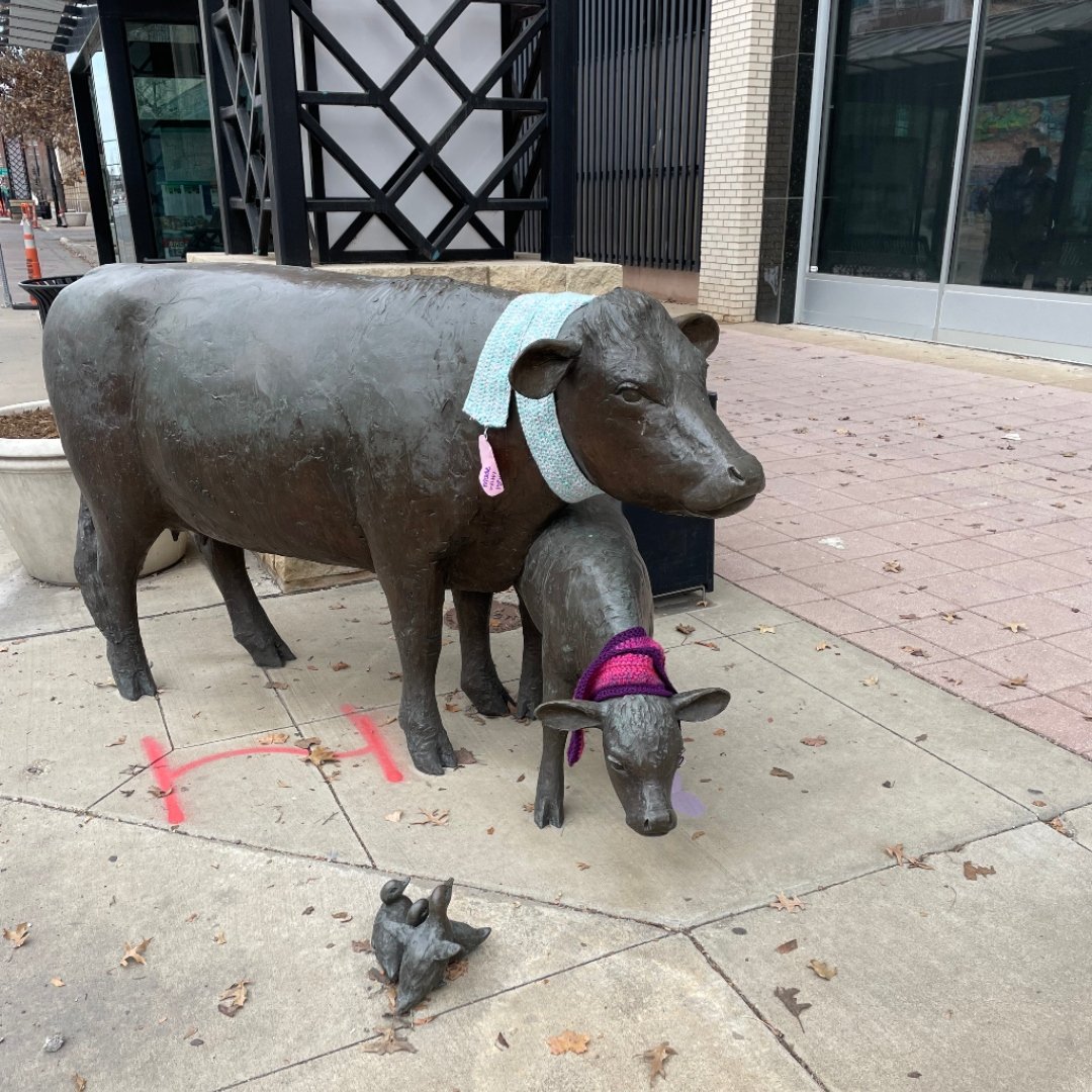 sculpture of 2 animals with scarves around their necks