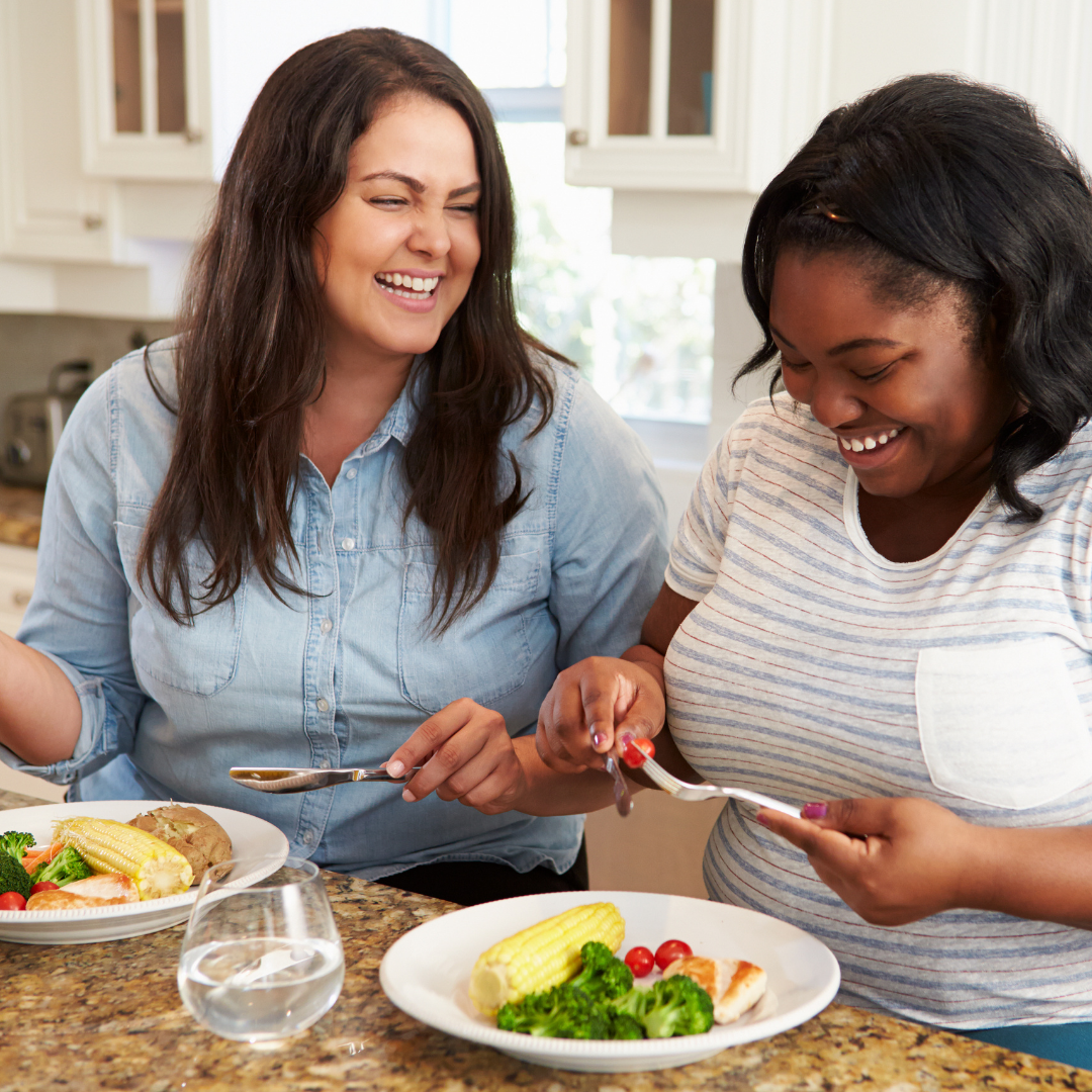 2 women eating dinner at a counter in the kitchen