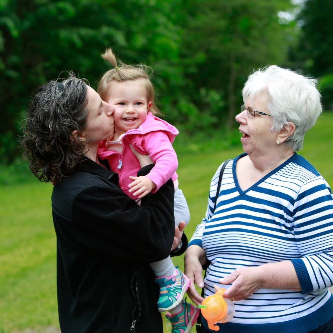 mom with baby talking with older woman