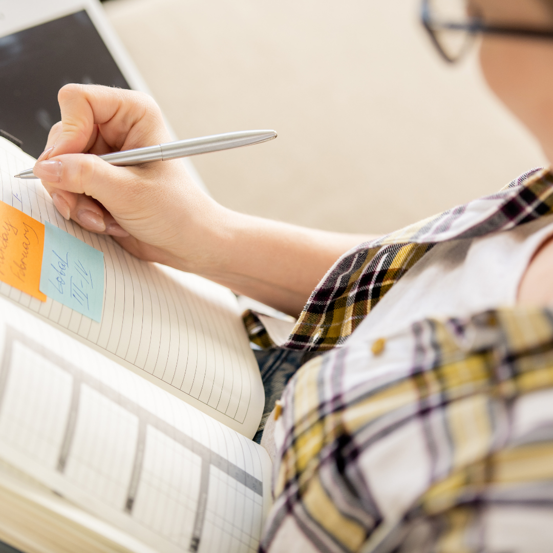 woman writing in planner