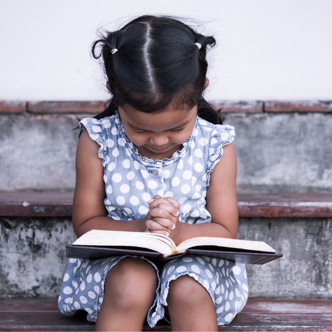 child reading a Bible