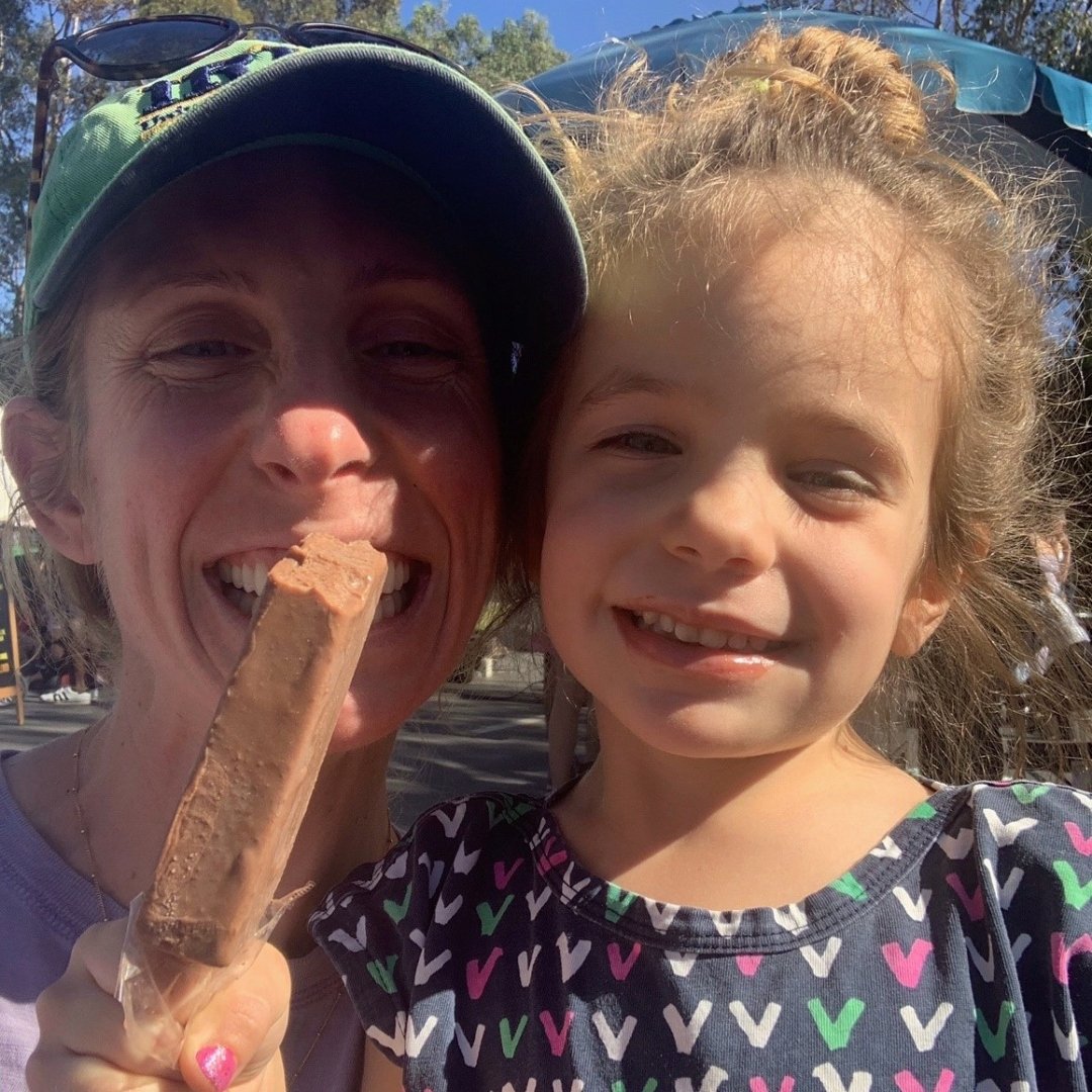 mom and little girl enjoying ice cream bar