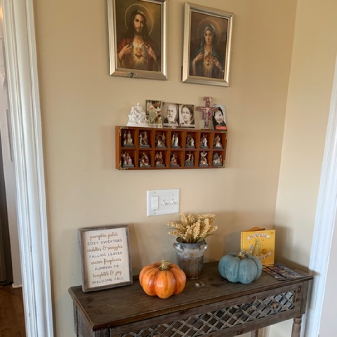 religious art above a hallway table