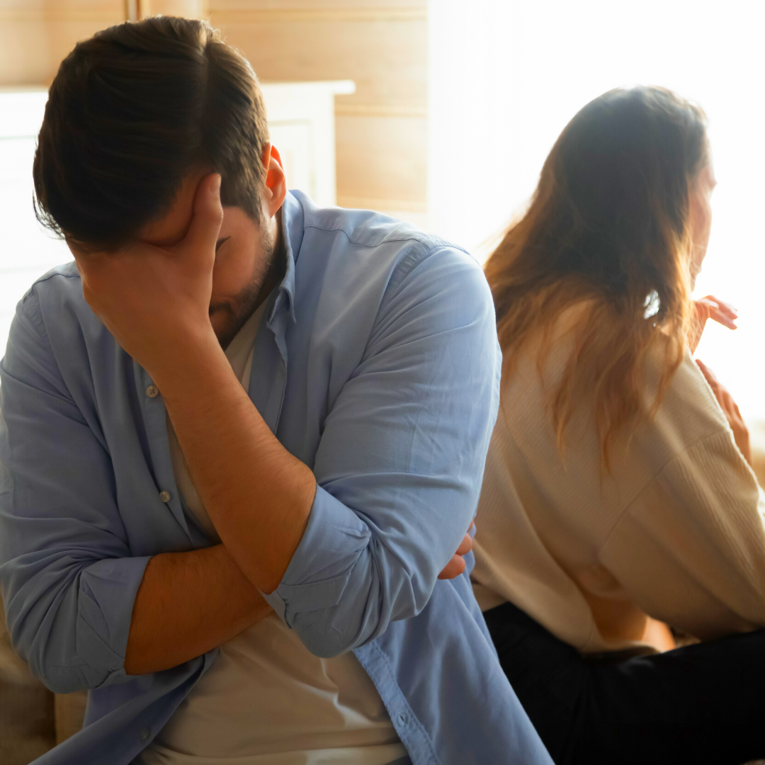 couple in an argument, backs to each other