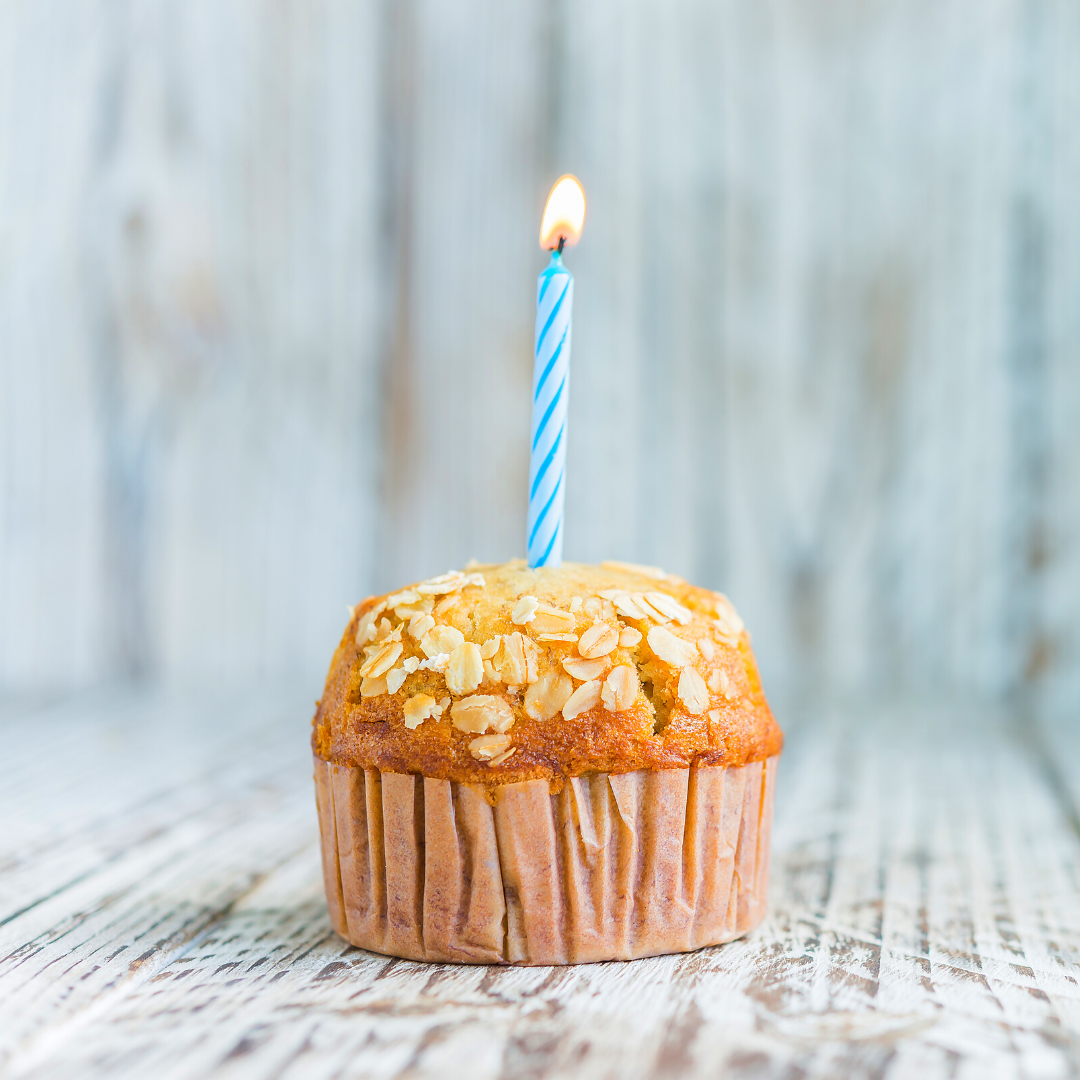 plain muffin with birthday candle in it