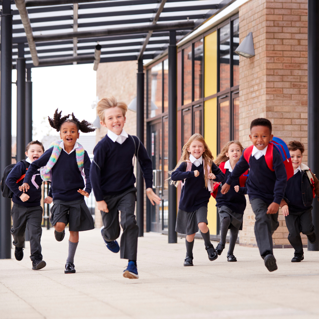 school children in uniforms, running