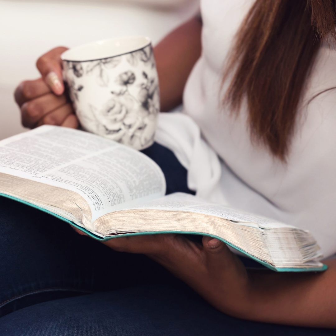 woman reading a Bible and a cup of tea