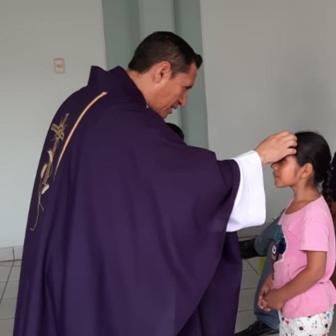 priest distributing ashes to child on Ash Wednesday