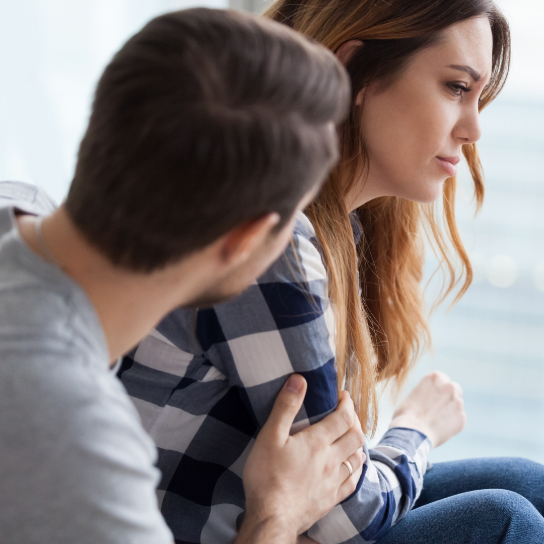 man consoling woman