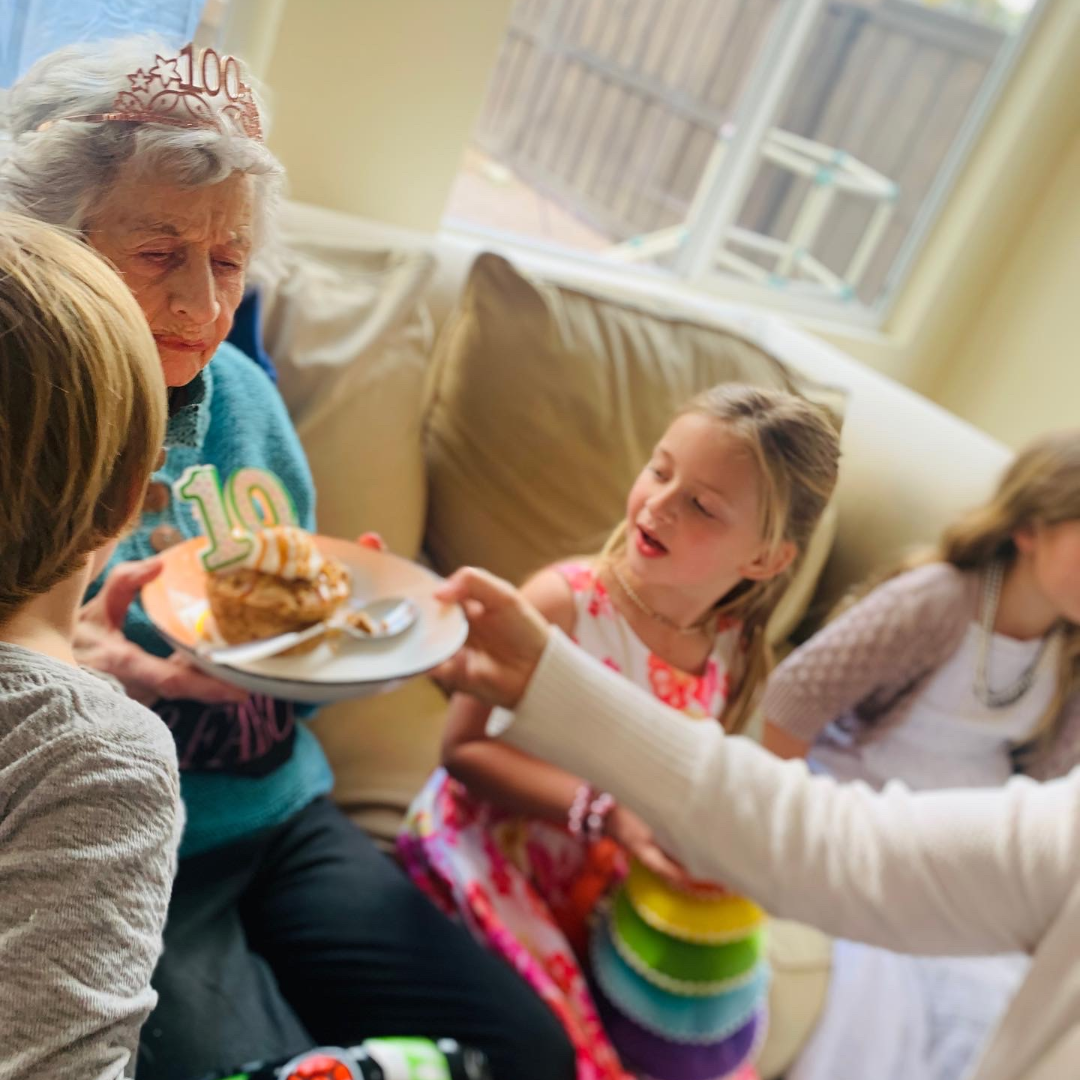 grandmother with great-grandchildren at her 100th birthday party