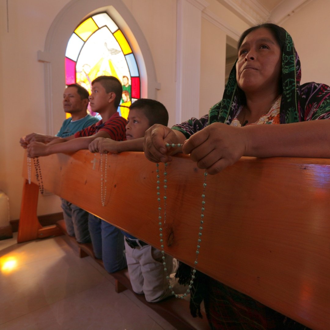 family praying in church