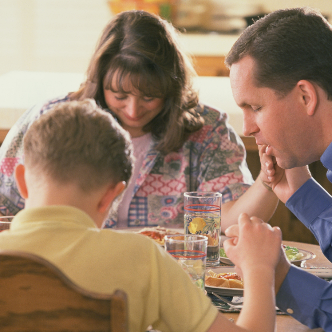 family praying at the table