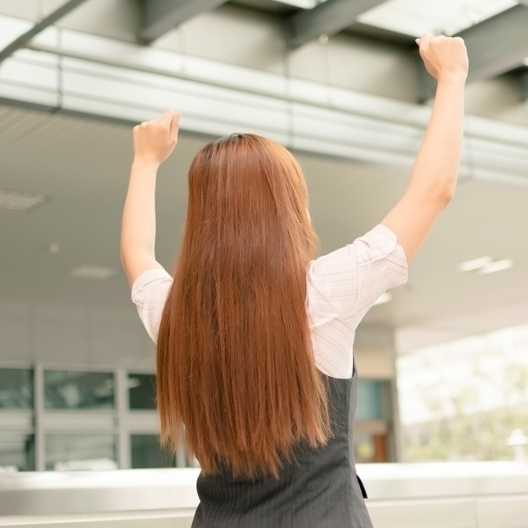 woman raising her hands in the air