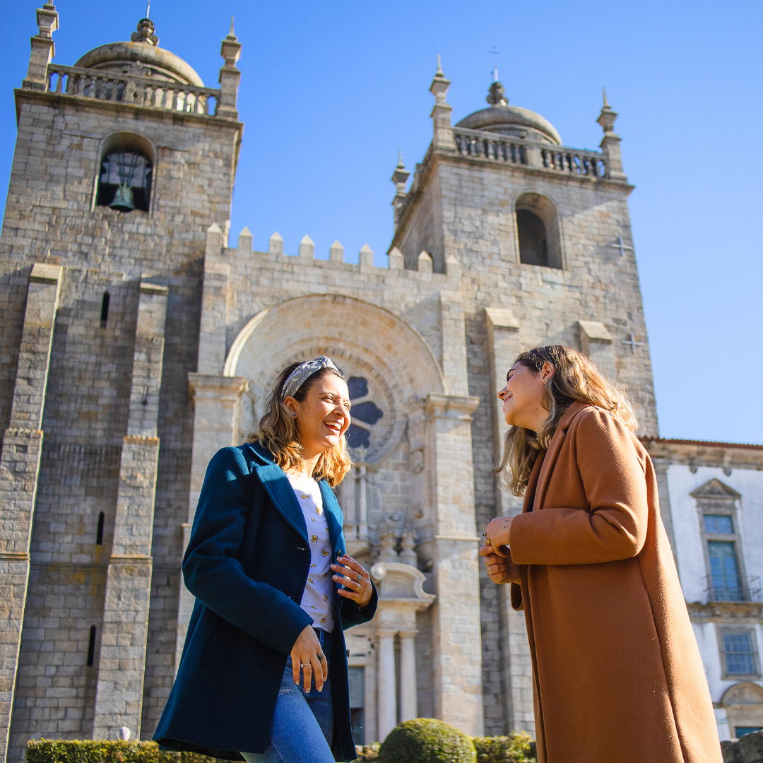 2 women laughing outside of a church