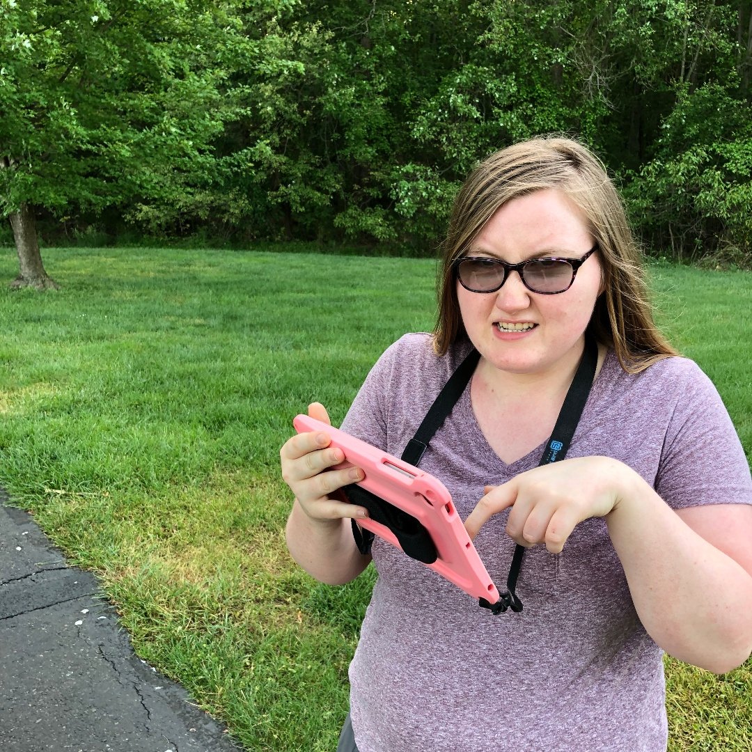 young woman with autism using an ipad to communicate