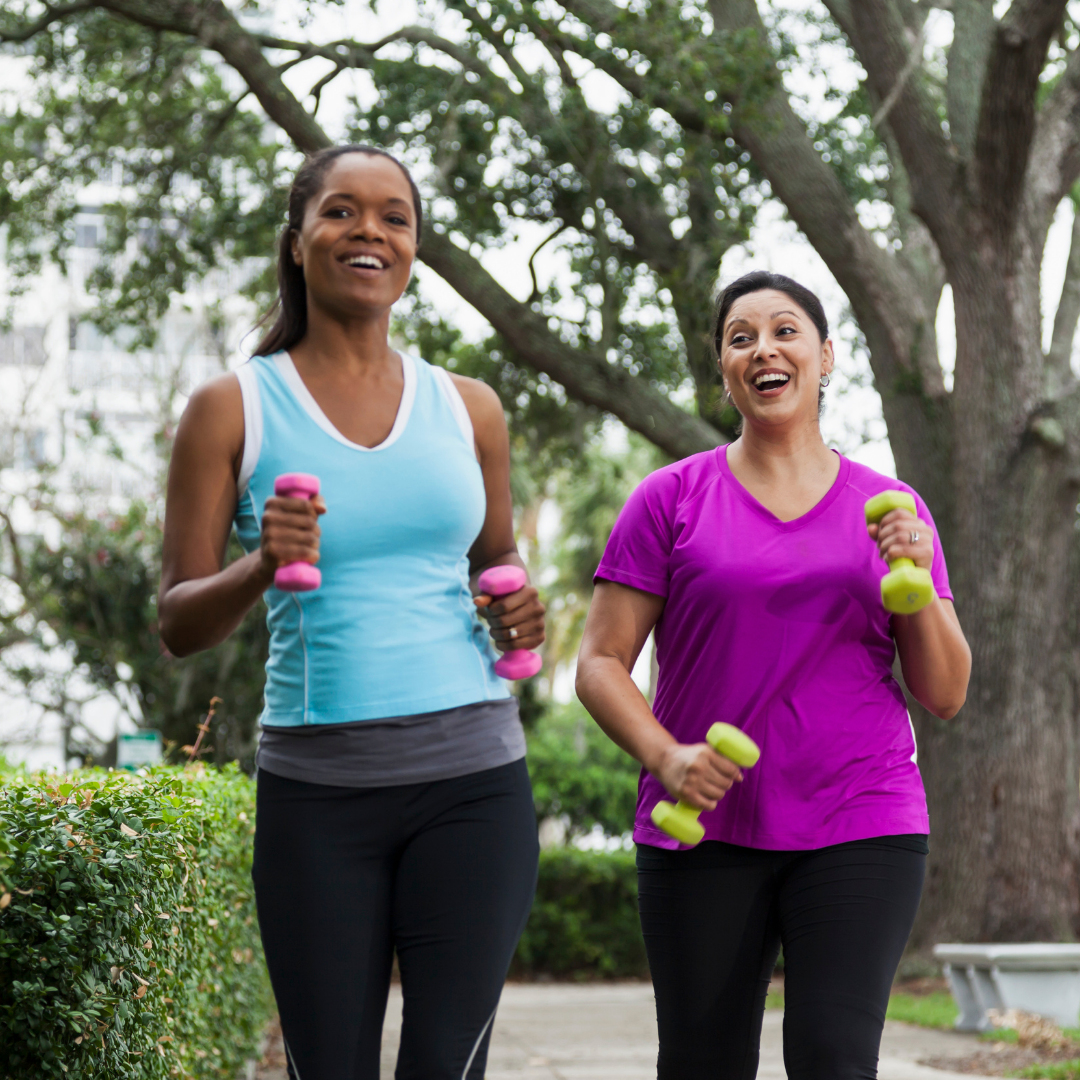 2 women walking with hand weights