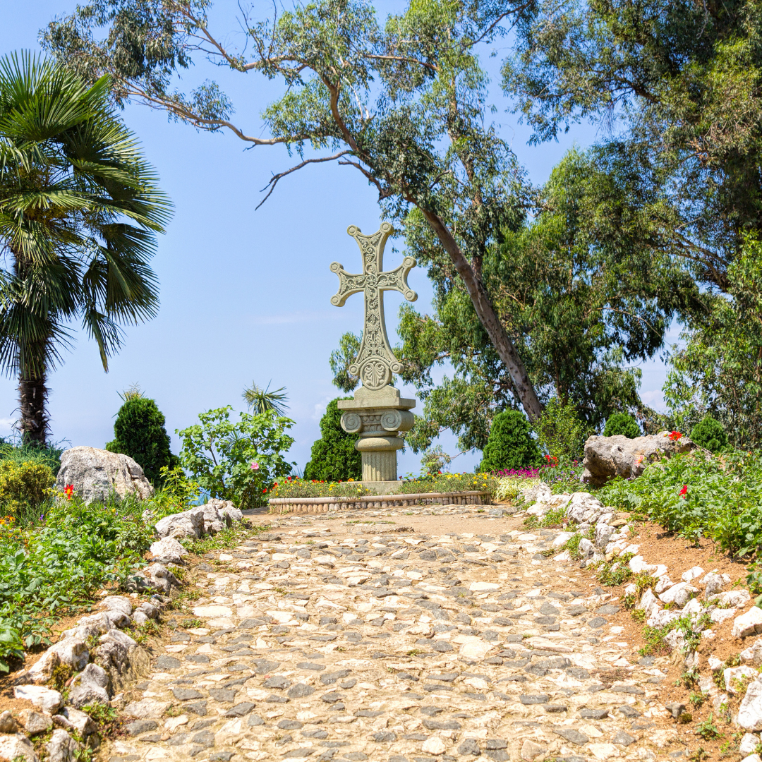 carved stone cross at top of a hill