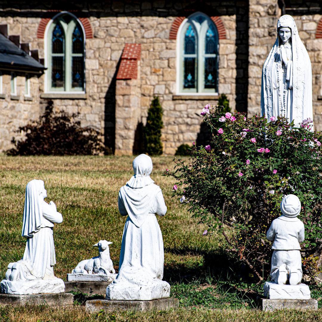 statues of Our Lady of Fatima and child visionaries outside a church