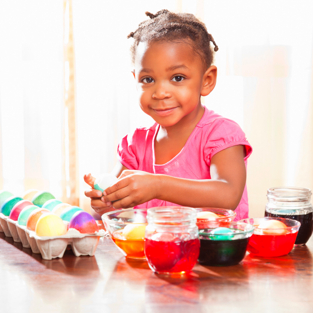 little girl coloring easter eggs